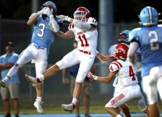							                                Dallas wide receiver Zach Paczewski (3) pulls in a touchdown scoring pass from quarterback Brady Zapoticky as Crestwoods linebacker Cole Kakalecik (11) tries to defend in the second quarter Friday night.                                 Fred Adams | For Times Leader					