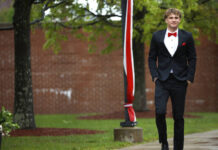 							                                Nicholas Pantages walks toward the school to join fellow graduates at MMI in Freeland.                                 Fred Adams | For Times Leader					