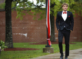 							                                Nicholas Pantages walks toward the school to join fellow graduates at MMI in Freeland.                                 Fred Adams | For Times Leader					