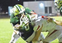 							                                Wyoming Area’s Trustin Johnson blasts through for a 5-yard touchdown run against Crestwood in Friday night’s season-opener.                                 Tony Callaio | For Times Leader					
