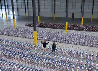 							                                Sen. Marty Flynn, left, stands with Sean Bingham, co-organizer of the bicycle distribution project, at a warehouse in Pittston Twp., where the 2,000 bikes were held for pick-up.                                 Submitted Photo					