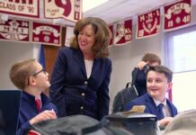 							                                Head of School Mrs. Theresa Long talking with MMI students 					