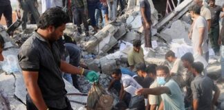 							                                A man holds a childs backpack as rescue workers and residents search through the rubble in the aftermath of a strike on a girls elementary school in Minab, Iran, Saturday, Feb. 28, 2026.                                 Abbas Zakeri/Mehr News Agency via AP					