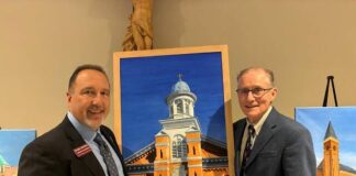							                                From left: Mark DiPippa, executive director of the Catholic Foundation for the Diocese of Scranton, and Austin Burke, artist/philanthropist and former president of the Greater Scranton Chamber of Commerce, with a painting of St. Thomas Aquinas Church in Archbald.                                 Submitted Photo					