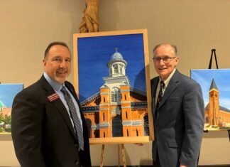 							                                From left: Mark DiPippa, executive director of the Catholic Foundation for the Diocese of Scranton, and Austin Burke, artist/philanthropist and former president of the Greater Scranton Chamber of Commerce, with a painting of St. Thomas Aquinas Church in Archbald.                                 Submitted Photo					