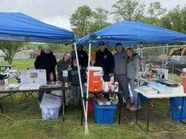 							                                Slocum Twp. Volunteer Fire Co. volunteers pose under the tents during the bake sale.                                  Photo via Brianna Burford					